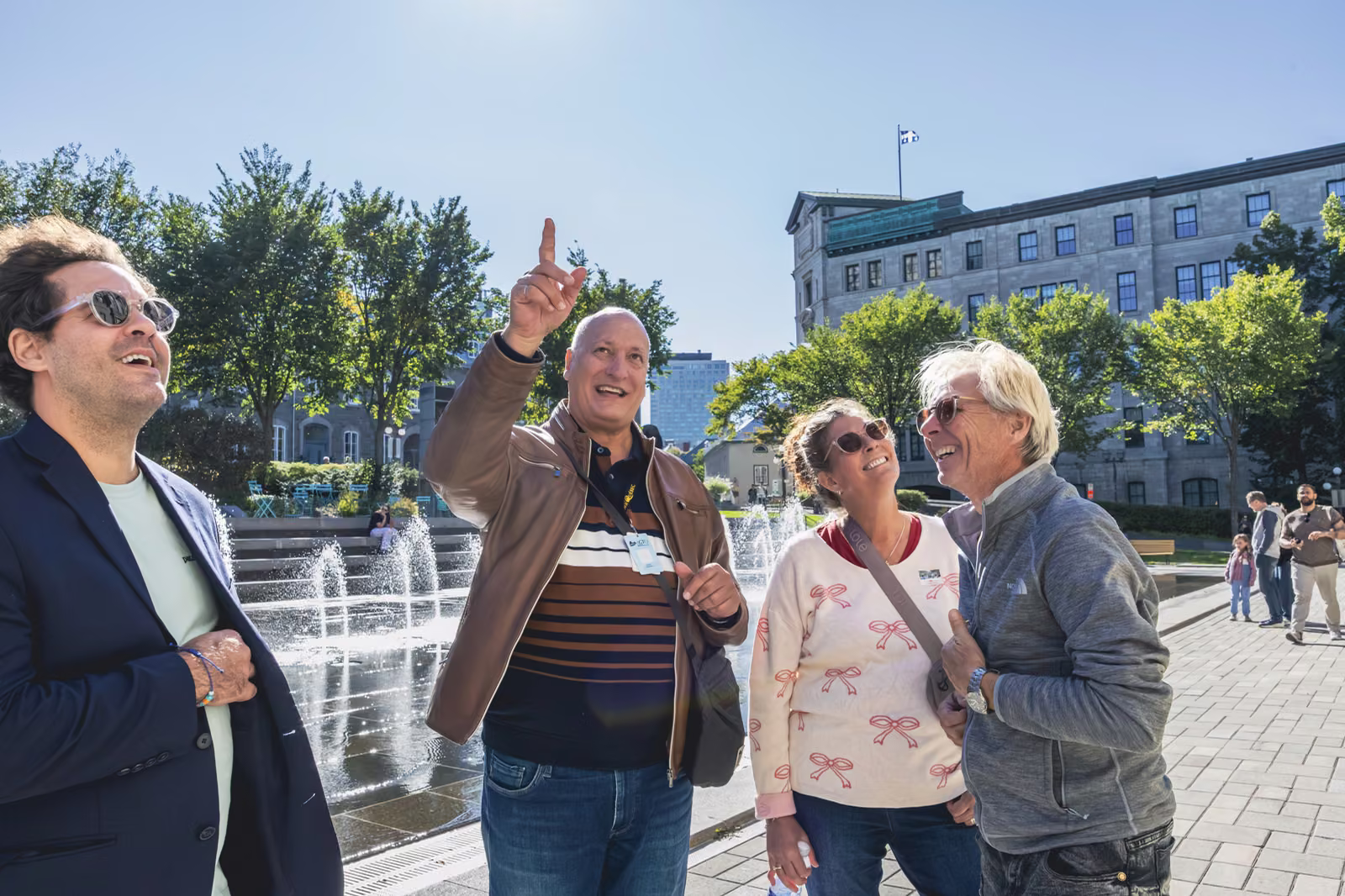 Visitors laughing and pointing out a landmark during a guided walk.