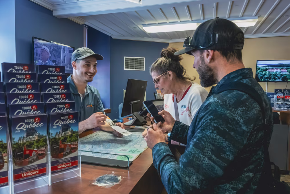 Visitors booking at the Tours Voir Québec desk in the Tourist Information Centre, 12 rue Sainte-Anne.