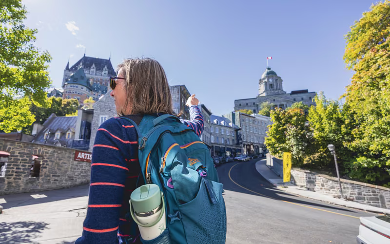 A visitor looking up at the Château Frontenac above Old Québec.