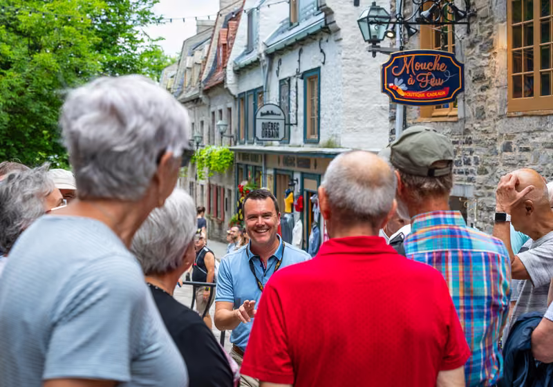 A guide telling stories to a group in the Petit-Champlain district.