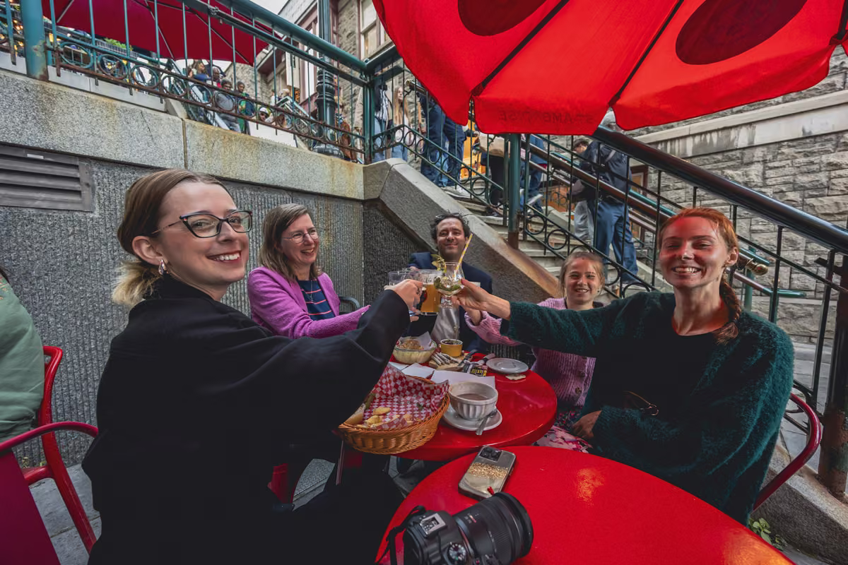 Friends toasting on a restaurant terrace in Old Québec.